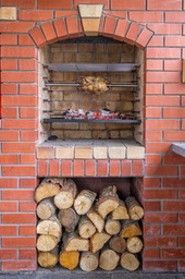 Spit roasting a Chicken above the Barbeque